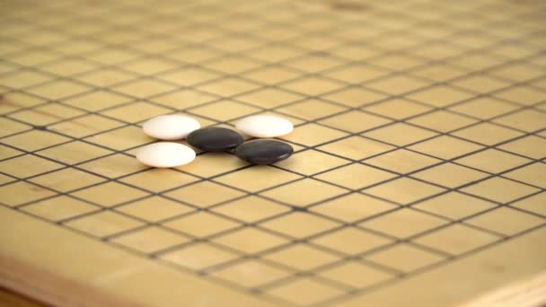 Китайська йти гри weiqi, граючи на дерев'яну шахівницю — стокове відео
