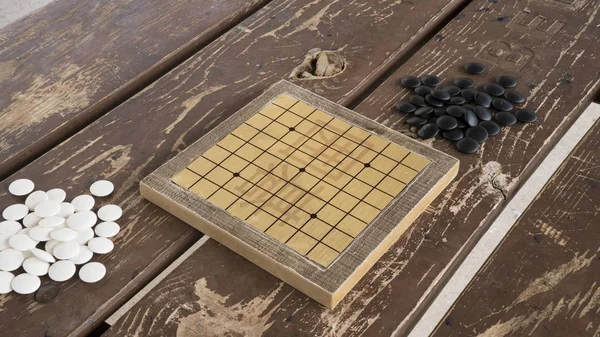 Kínai megy vagy Weiqi társasjáték. Fekete-fehér kövek és kézzel készült kis tábla. — Stock Fotó