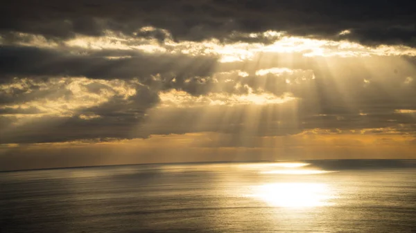 Zonsondergang en zon verlichting komt tussen wolken Oceaan Rechtenvrije Stockfoto's