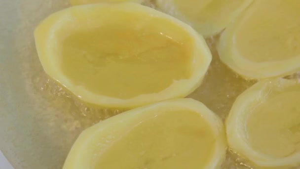 Big potato sliced chips frying in ceramic pan. Boiling oil. Close up. — Stock Video