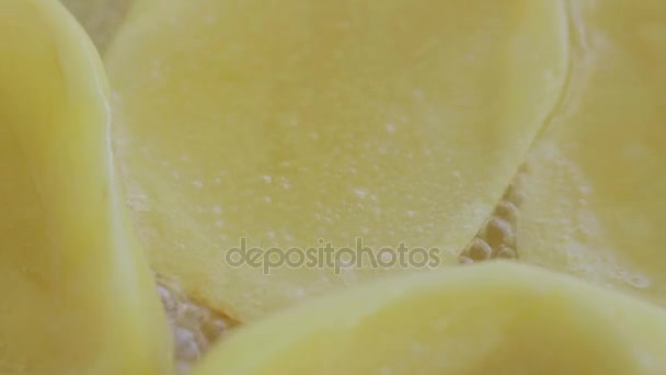 Grandes frites de pommes de terre tranchées dans une poêle en céramique. Huile bouillante. Ferme là. Macro shot . — Video