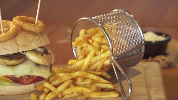 Hambúrguer americano com queijo, carne bovina, tomate, alface e cogumelos, batatas fritas e refrigerante refrigerante com fatia de limão. Tiro Pan. Fechar pan-shot . — Vídeo de Stock