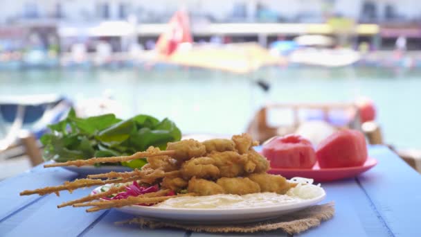 Sült kagyló botokkal és fa kék asztal, a tenger a Foca Izmir Törökország mártással — Stock videók