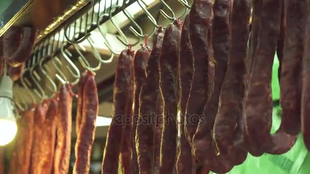 Salsichas defumadas e secas penduradas no mercado de carnes de açougueiro do Mercado Municipal Paulistano São Paulo, Brasil . — Vídeo de Stock