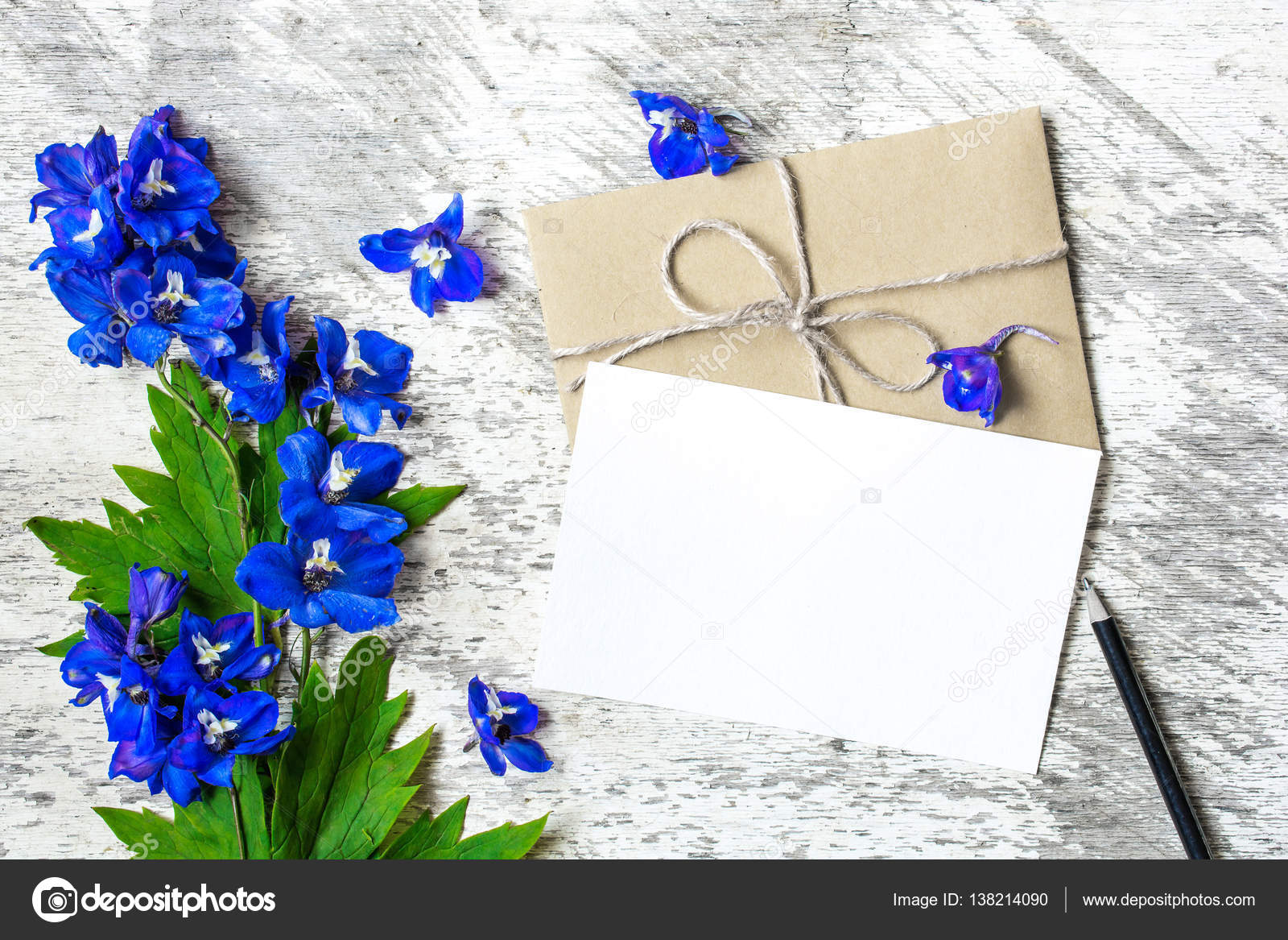 Bouquet of blue wildflowers and blank white greeting card with envelope  Stock Photo by © 138214090