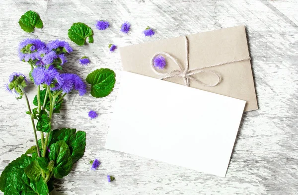 Bukett av vilda blommor och tomma vita gratulationskort — Stockfoto