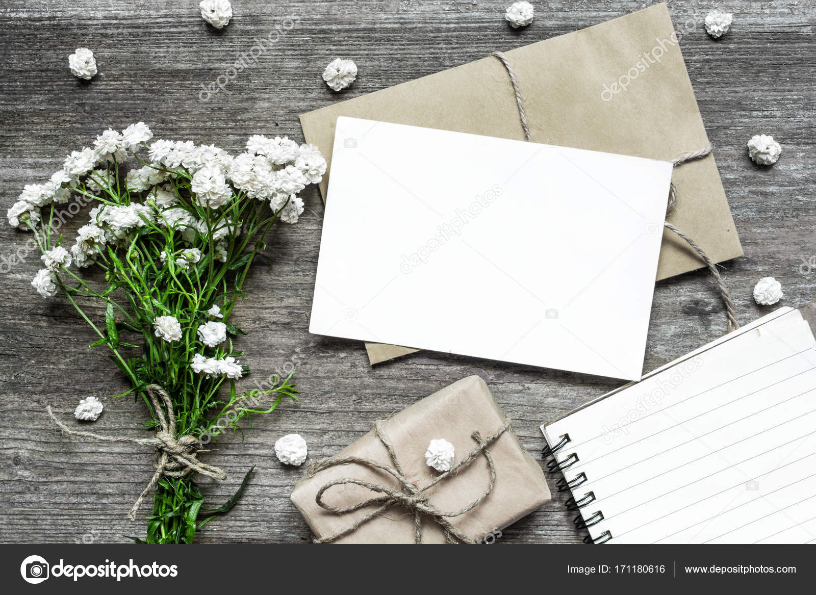 Blank white greeting card with white flowers bouquet and envelope with