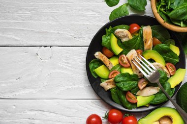 çatal ile siyah plaka kiraz domates, ıspanak, tavuk ve Avokado salatası