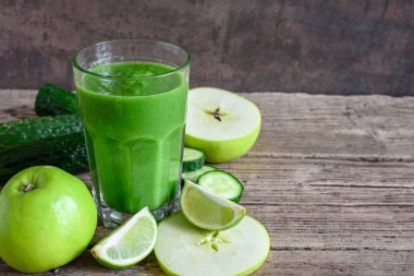 bir bardak ıspanak, elma, salatalık ve kireç rustik ahşap masa üzerinde yeşil sağlıklı güler yüzlü. Detoks içecek