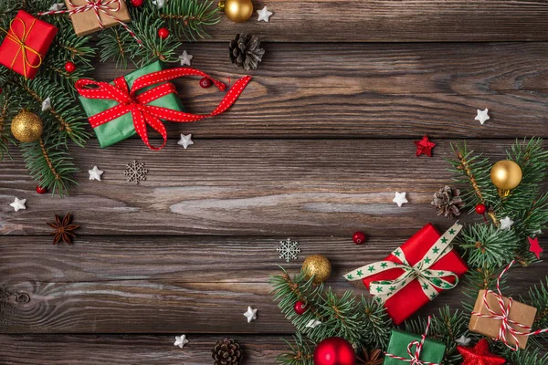 Vánoce a šťastný nový rok pozadí. jedle větve stromů s červenou dovolenou dekorace a dárkové krabice — Stock fotografie