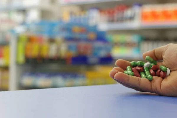 Medicine on the palm of hand with blurred background