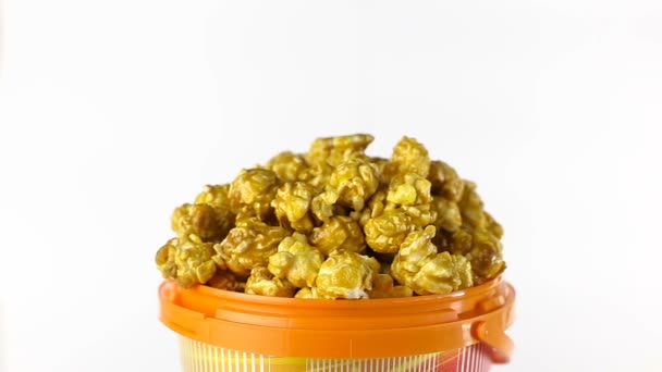 Karamelový popcorn se otočí na bílém pozadí. Detailní záběr záběr — Stock video