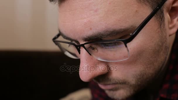 Portrait of a young man with glasses who works with tablet — Stock Video