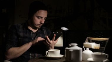 Tablet bilgisayar cafede akşam kullanan adam