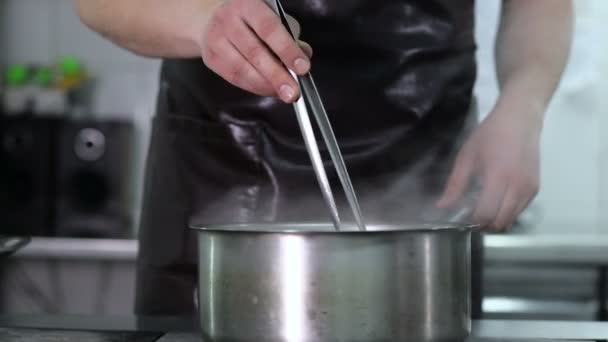 De chef-kok kookt spaghetti op de Pro-keuken — Stockvideo