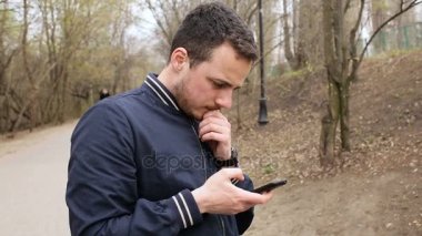 Adam cep telefonu ile parkta