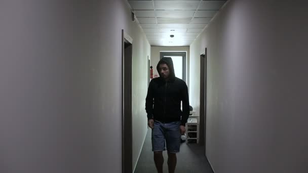 Zloděj krade chodbou a rozbije dveře do bytu — Stock video