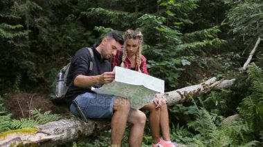 Bir adam ve bir kız ormanda bir harita olan bir yol arıyoruz