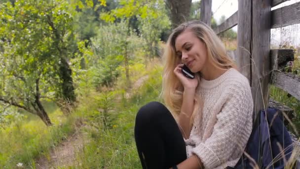 Woman talk on cell phone on a mountain road — Stock Video