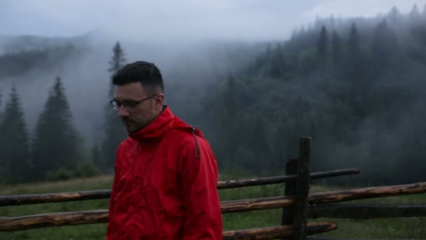 Portrait of a handsome young man in the evening in the mountains — Stock Video