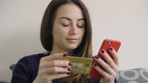 Young woman shopping online using phone lying in bed — Stock Video