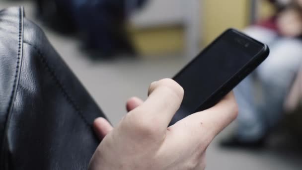 Primer plano de las manos masculinas utilizar el teléfono inteligente durante el viaje en metro — Vídeo de stock