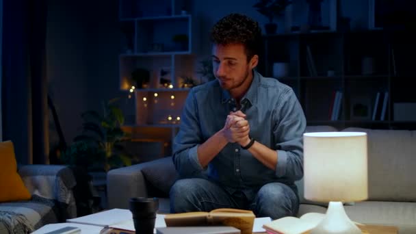 Young man studying at home in the evening — Stock Video