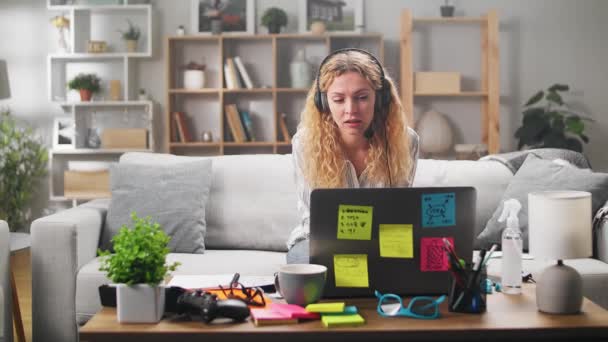 Het meisje werkt thuis, adviseert tijdens een videoconferentie — Stockvideo