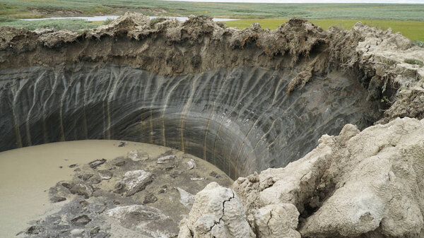 YAMAL PENINSULA, RUSSIA - JUNE 18, 2015: Expedition to the giant funnel of unknown origin. Crater view.