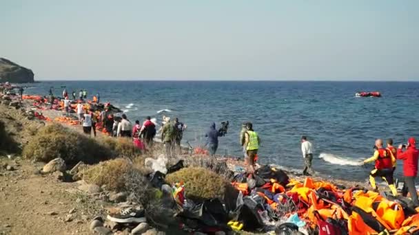 Lesvos, Yunanistan - 5 Kasım 2015: yaklaşan tekneye göçmenlerle çalıştırmak insanlar. — Stok video