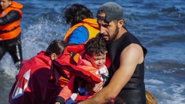 Lesvos, Yunanistan - 15 Kasım 2015: Çocuk tekneden alınır.