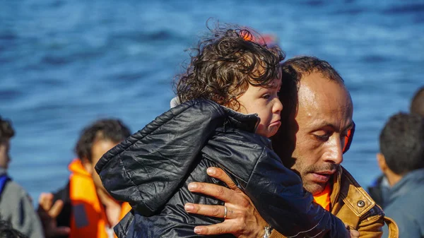 LESVOS, GRECIA - 15 NOVEMBRE 2015: I bambini vengono tirati fuori dalla barca . Foto Stock