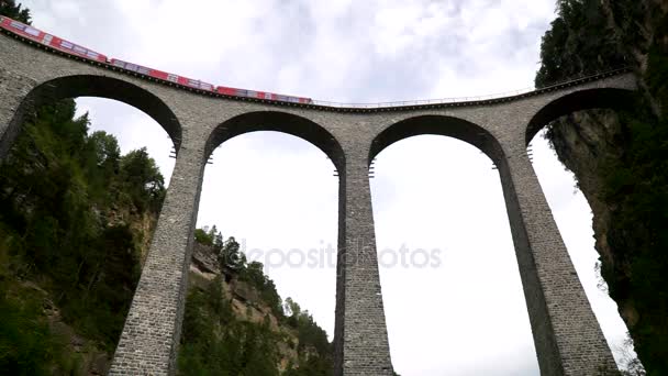 The train passes through the famous Landwasser viaduct in Switzerland. — Stock Video