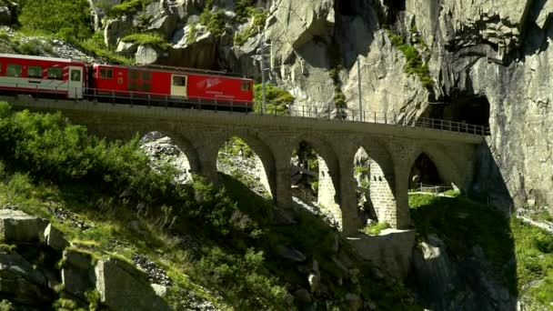 El tren pasa por el viaducto. Coloque cerca del puente de los demonios. Andermatt, Suiza . — Vídeos de Stock