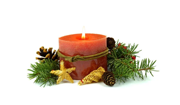 Burning candle, fir , cones, straw toys, decorative red berries. — Stock Photo, Image
