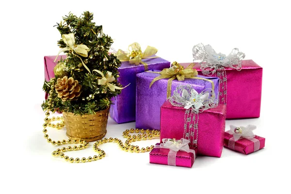 Many christmas gifts near a fur-tree.The holiday comes close. — Stock Photo, Image