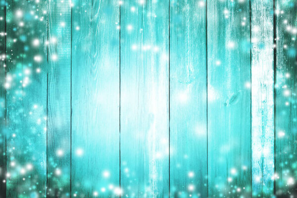 Blue magic glowing winter background. Christmas. Lights and snow. Bright wooden texture. Winter. New Year. Celebration.
