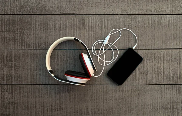 スマート フォンと木製の背景にヘッドフォン。音楽に耳を傾ける — ストック写真