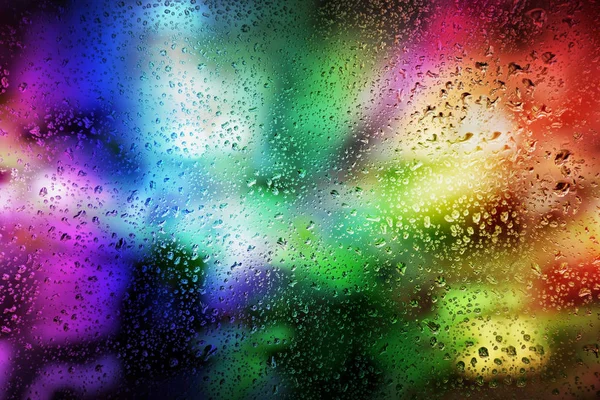Абстрактний фон: яскраві вогні та краплі дощу на склі. німецьких — стокове фото