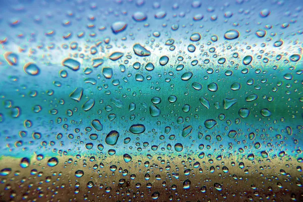 Gotas de agua sobre un fondo azul. Primer plano . —  Fotos de Stock