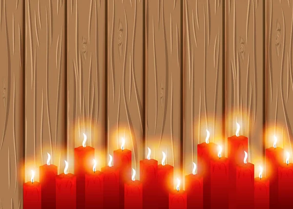 Burning candles on a wooden background. cosiness.