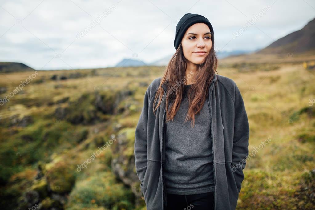 Female tourist hiker visiting a national park in Iceland. Wind and rain during camping.Tourist woman exploring wild nature.Nature and environment appreciation.Hiker acchievement