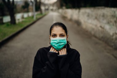 Scared sick woman wearing protective mask.Suffering from infectious disease.Infected patient suffering from symptoms of illness.Panic and fear of infection.Life in contaminated area.Nosophobia clipart