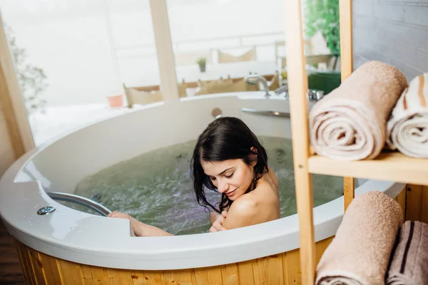 Woman relaxing at home in the hot tub bath ritual.Spa day moment in modern bathroom indoors jacuzzi tub.Body care.Good personal hygiene routine.Skincare,spa,aromatherapy.Bath essential oils.Antistress