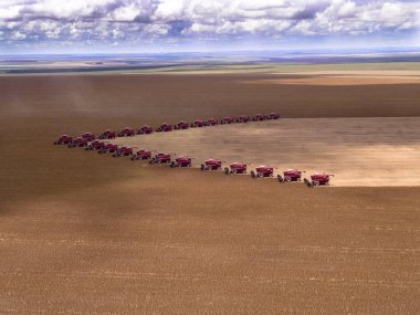 Mass soybean harvesting at a farm in Campo Verde clipart
