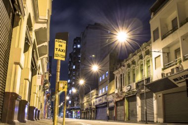 Sao Paulo, SP, Brazil, June 08, 2017. Night view of buildings on a street in the neighborhood of Santa Ifigenia, central region of Sao Paulo clipart