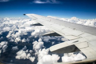 Aerial view from the window of and airplane during a flight clipart