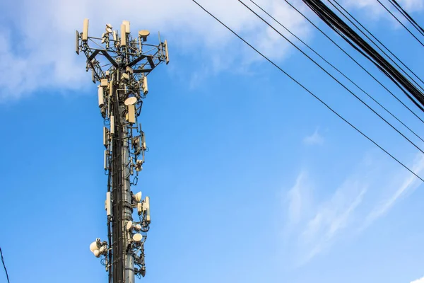 Telecommunication tower with copy space.Digital wireless connection system.Development of communication systems in urban areas.Modern Business Communication Concept.Antenna, and pole with electric line in Sao Paulo