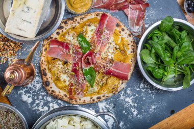 Kabak pesto, jambon, gorgonzola ve tohumlar Siyah Kara tahta üzerinde geleneksel İtalyan pizza