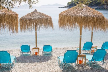 Şezlong şemsiye Yunan Sahil üzerinde ile